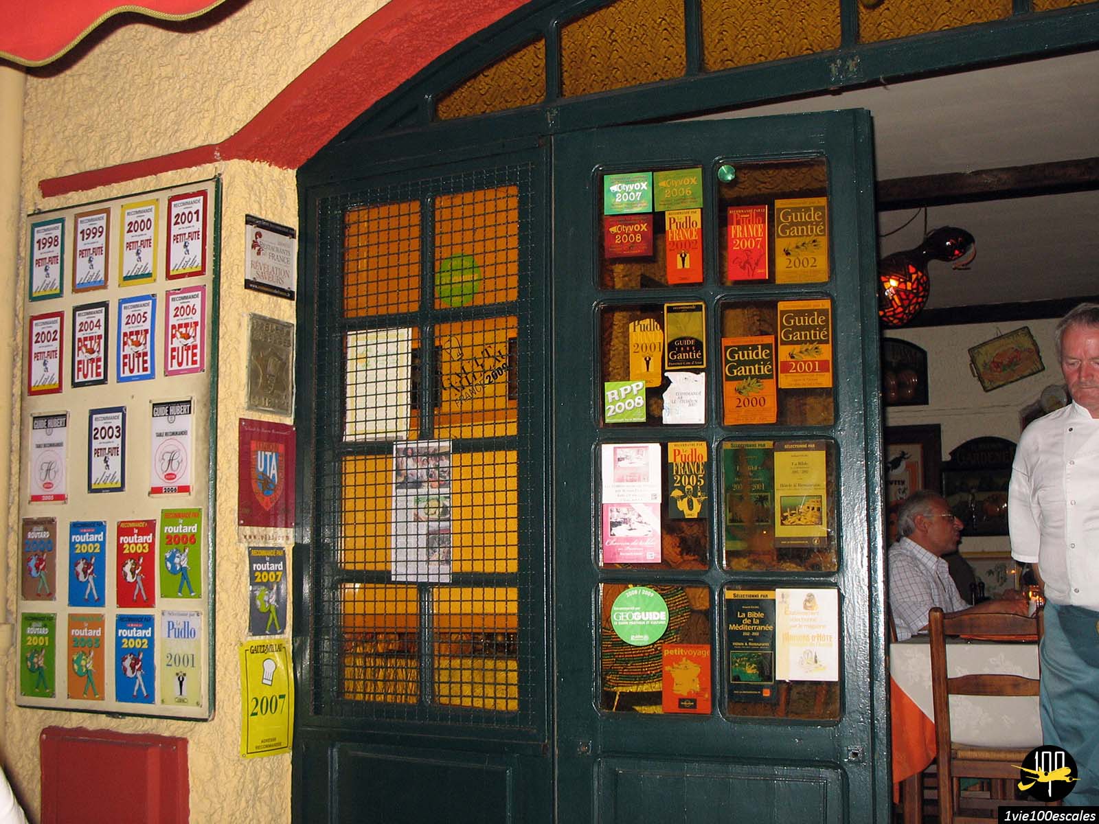 Les nombreuses distinctions affichées sur les portes du restaurant La Zucca Magica
